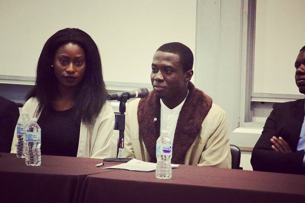 Emmanuel speaking on a panel at Brown University